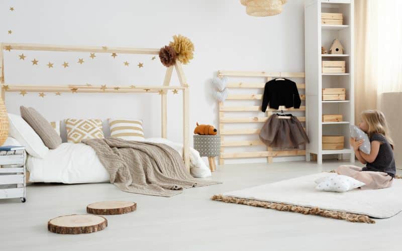 Girl in bedroom with recycled wooden furniture