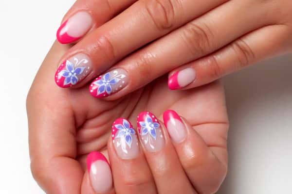 Almond shaped nails with spring blue flowers and a pink tip