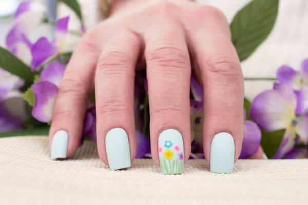 Pastel blue square nails with a spring floral desing in one of the nails