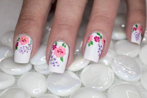 White square nails with a colorful spring floral pattern