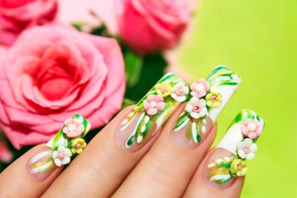 3d Nails with a clear and white base and three dimensional pink and white flowers