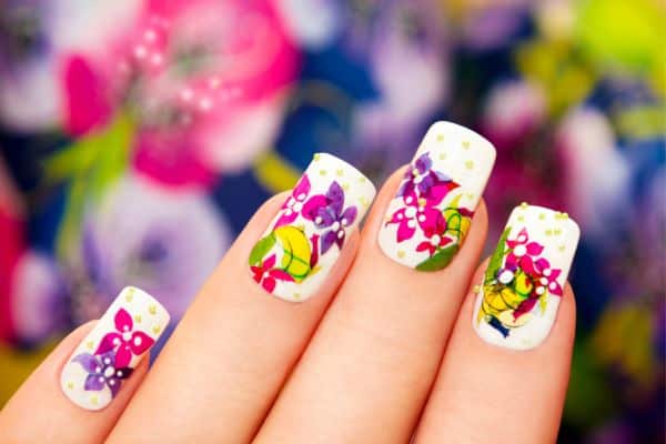 Square nail desing with colorful spring flowers on a white base