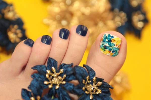 Black pedicure with a colored butterfly design in the big toe