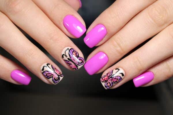 Square pink nails with a butterfly design in 3 butterflies on a white background