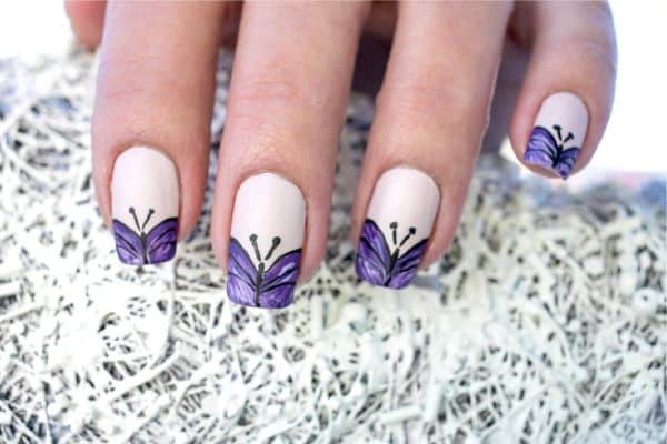 Purple butterfly manicure painted on white nail polish