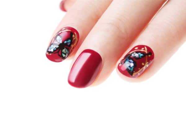 red nails with a butterfly design