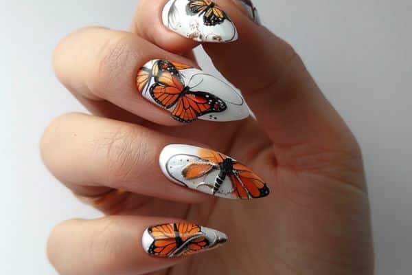 stiletto white nails with orange butterflies