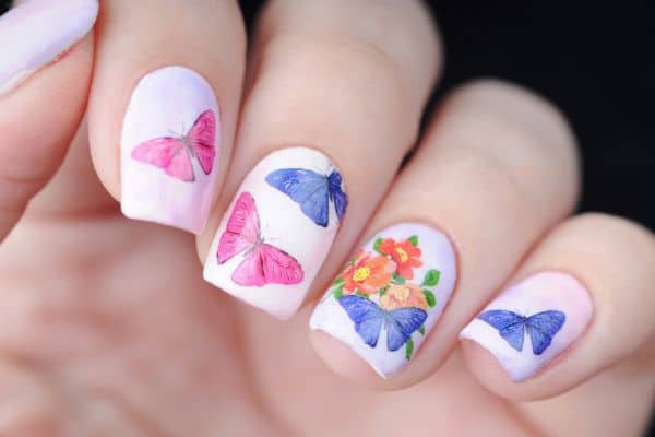 White nails with blue and pink butterflies