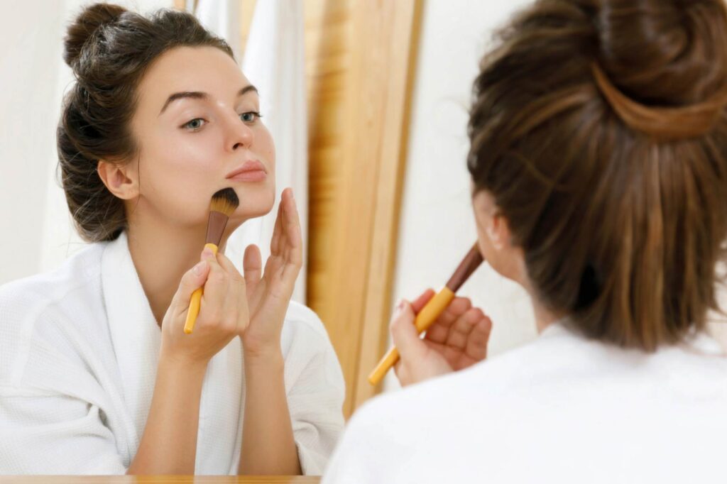 A woman applying foundation to her face