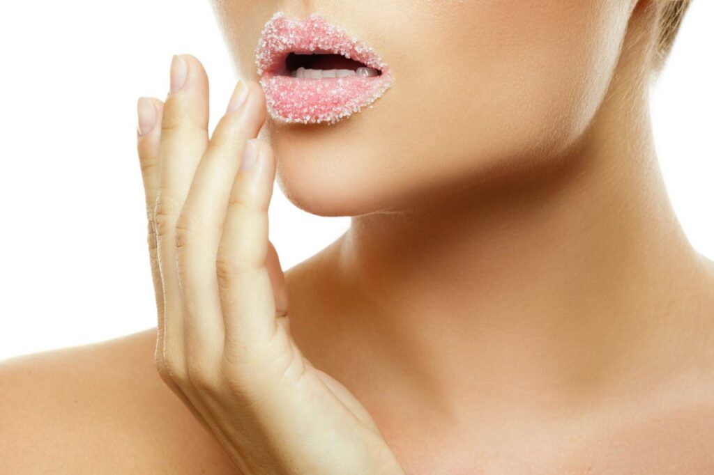 A woman with sugar scrub on her lips