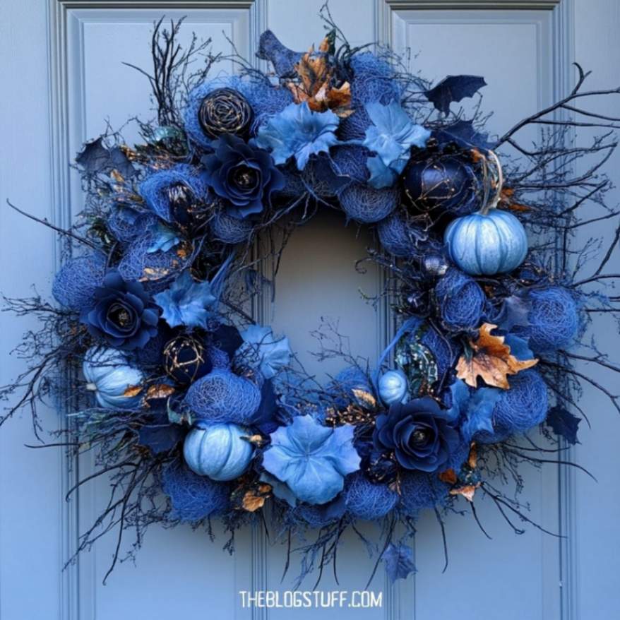 Blue Halloween wreath with roses, pumpkins, and floral accents.