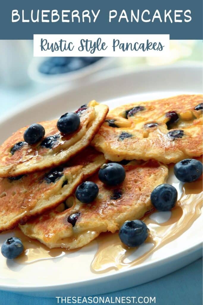 Rustic-style blueberry pancakes topped with syrup and fresh blueberries on a white plate.