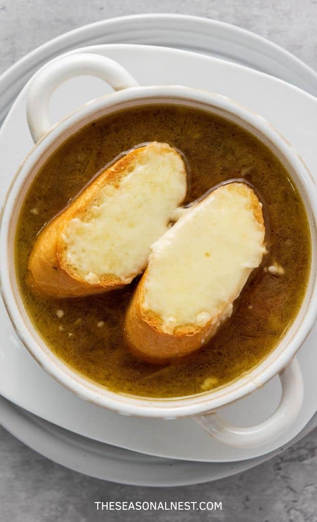 French soup in a bowl with 2 baguette slices.