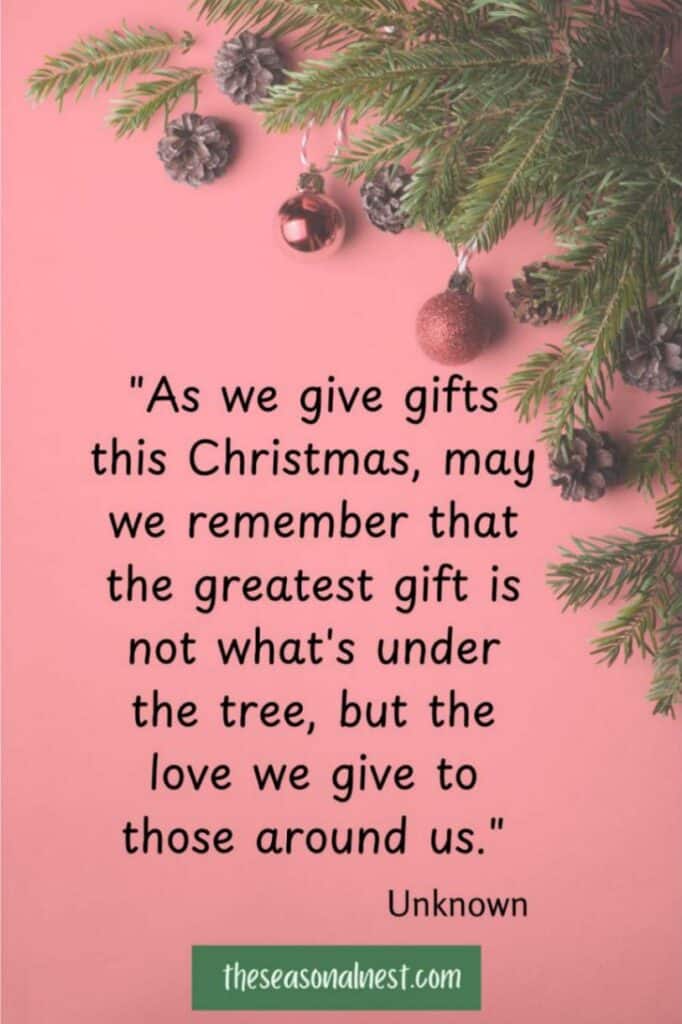 A pink background with evergreen sprigs, metallic ornaments, and a heartfelt beautiful Christmas quote.