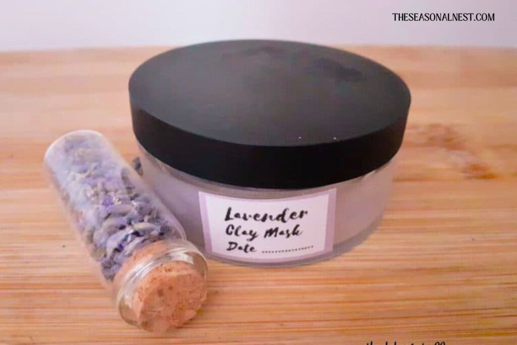DIY lavender clay mask in a container with lavender seeds in another container.