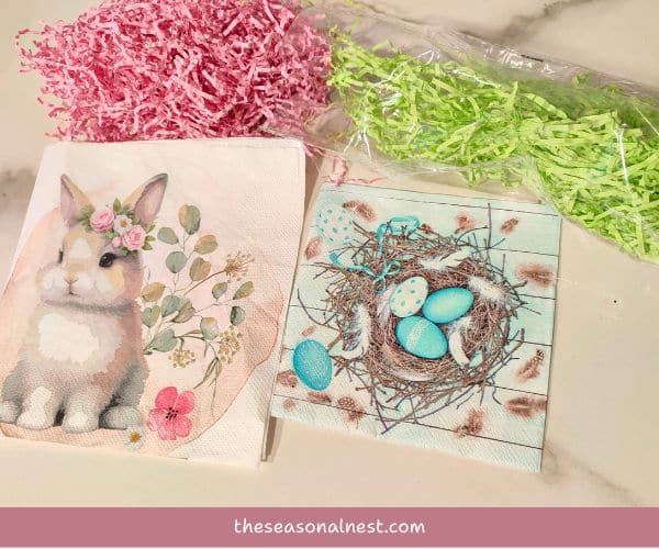 Easter crafting materials, including bunny and bird nest napkins, and pastel shredded paper ready for Easter jar crafts