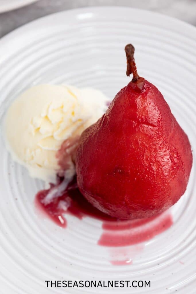 Wine Poached Pear with vanilla ice cream on a plate