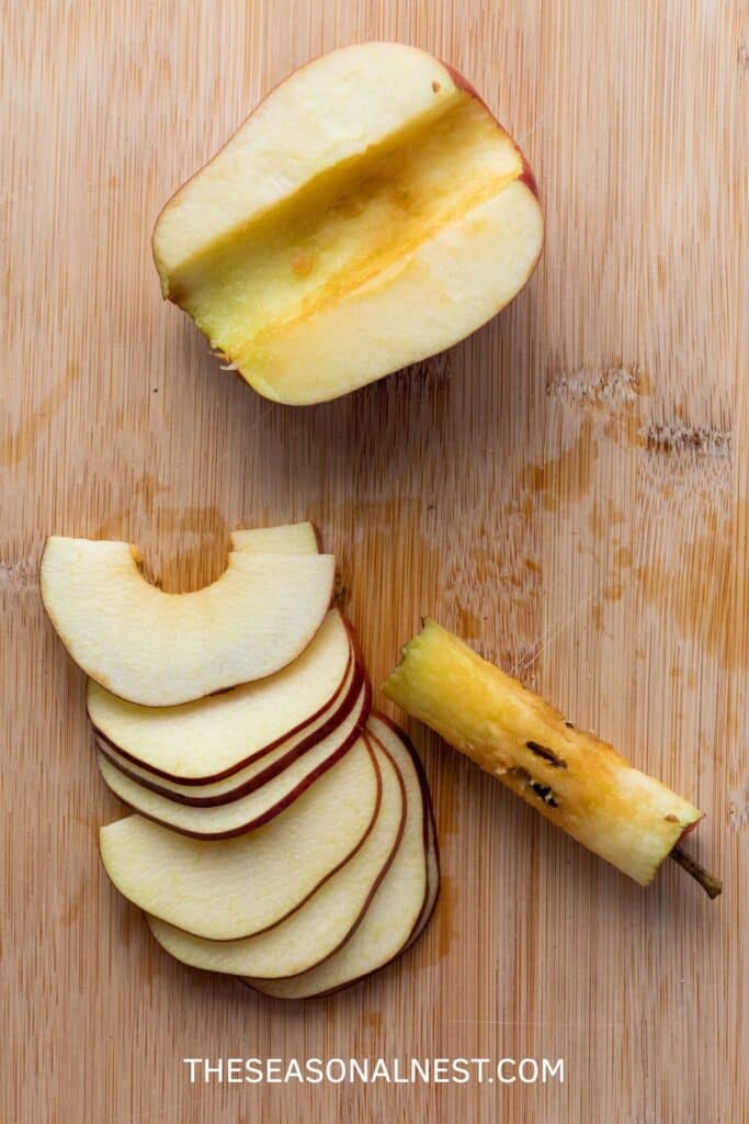 Sliced apples on a cutting board, ready to be used for homemade upside-down apple tarts.