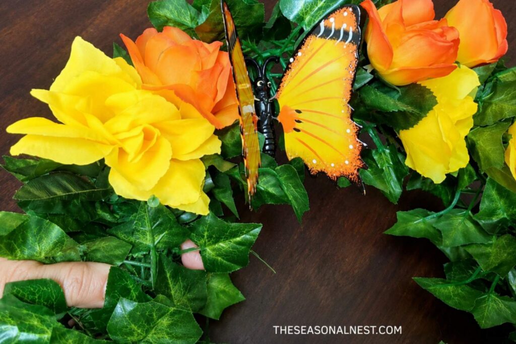 Adding ornaments like a butterfly to the wreath