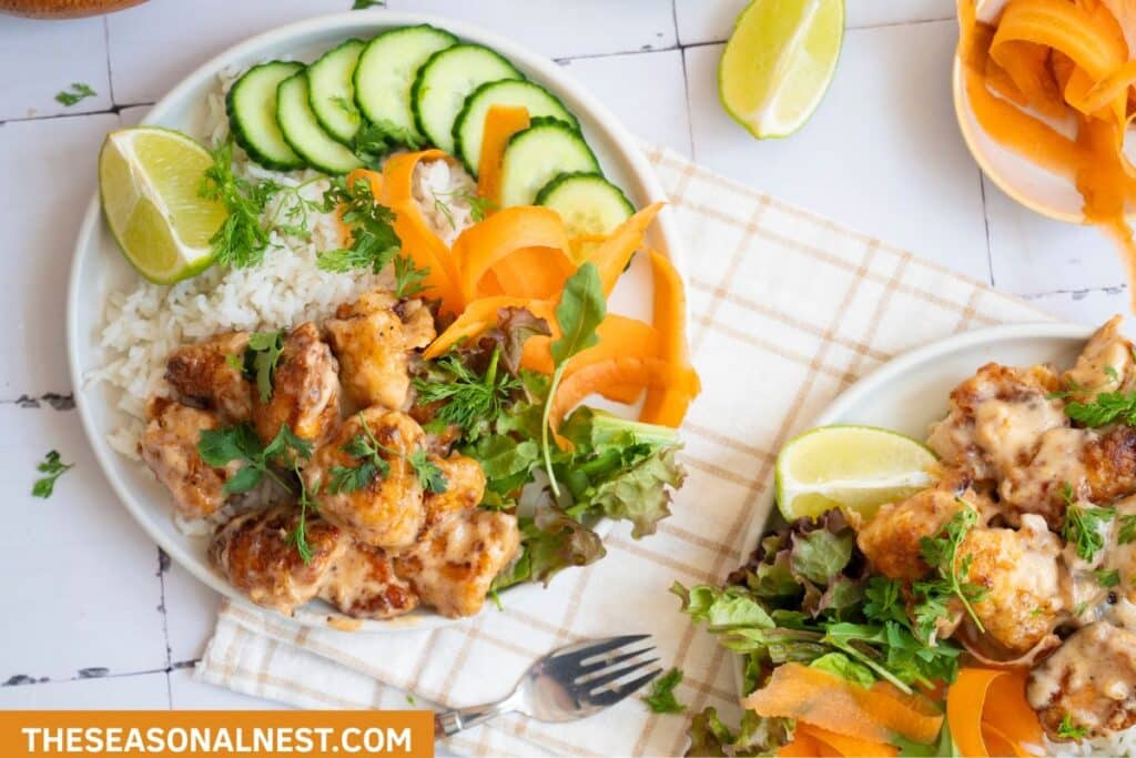 Healthy Bang Bang Chicken Rice Bowl with Colorful Vegetables served on a plate.