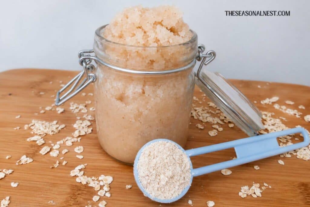 Homemade oatmeal body scrub with a spoon full of oats.