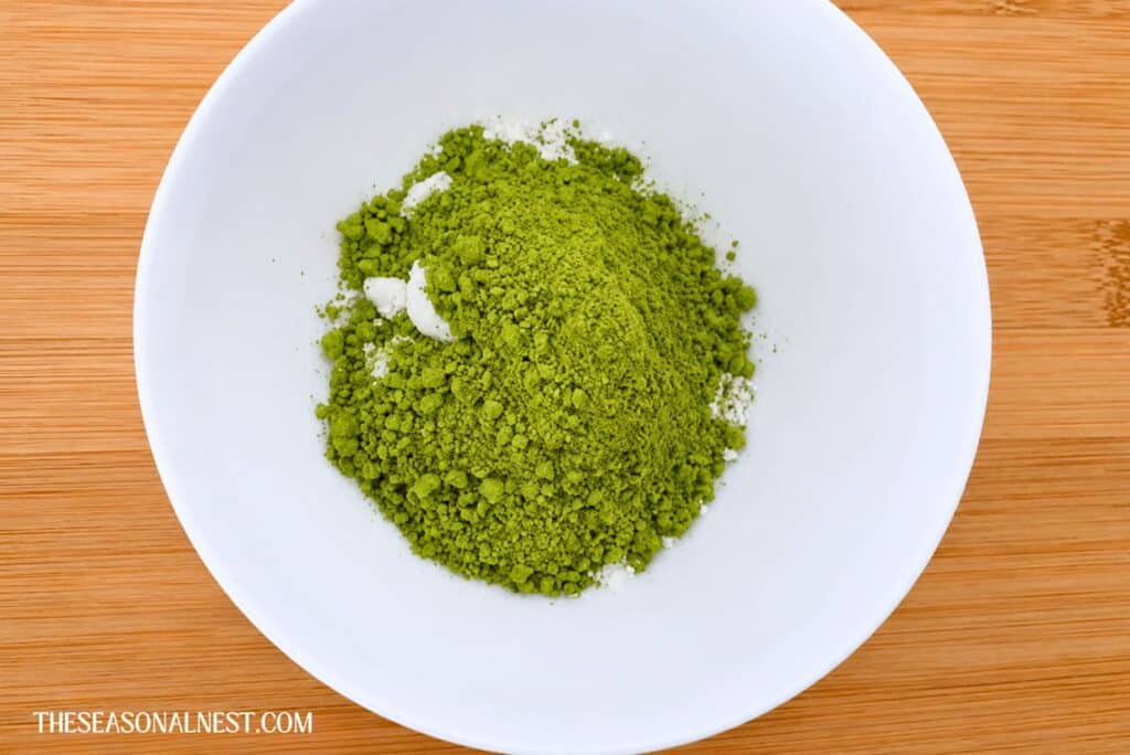 Mixing matcha powder and ground oats.