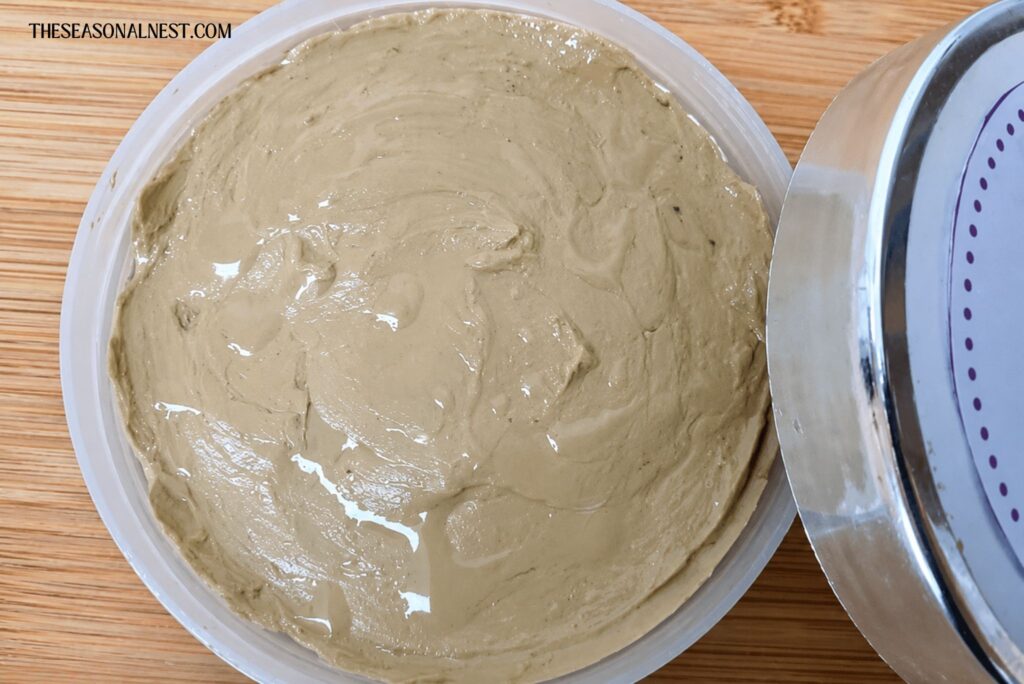 Bentonite clay mask in a container with a lid.