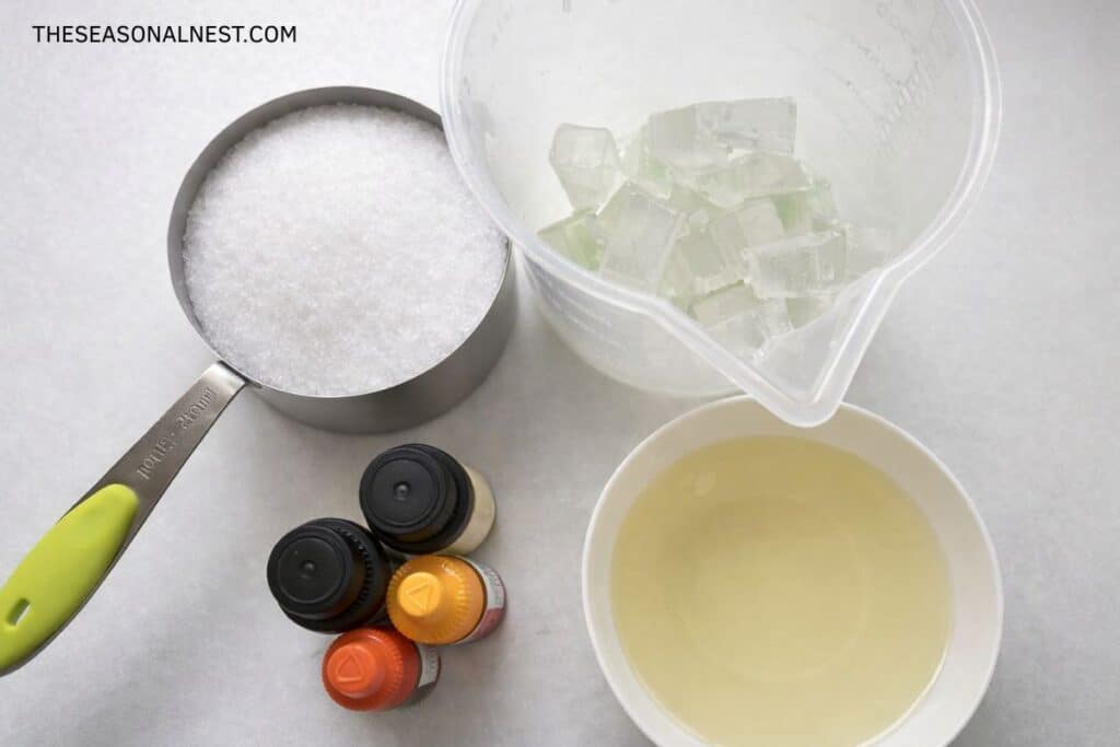 Ingredients to make orange and lemon sugar scrub cubes with soap.