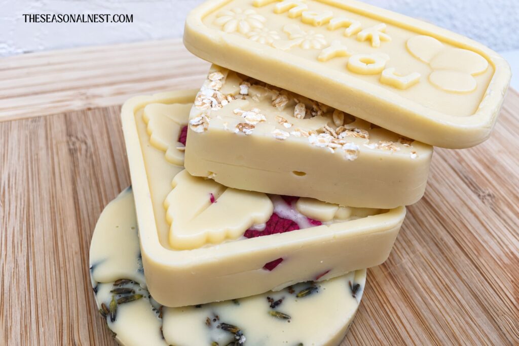 A stack of homemade lotion bars on a wooden background.