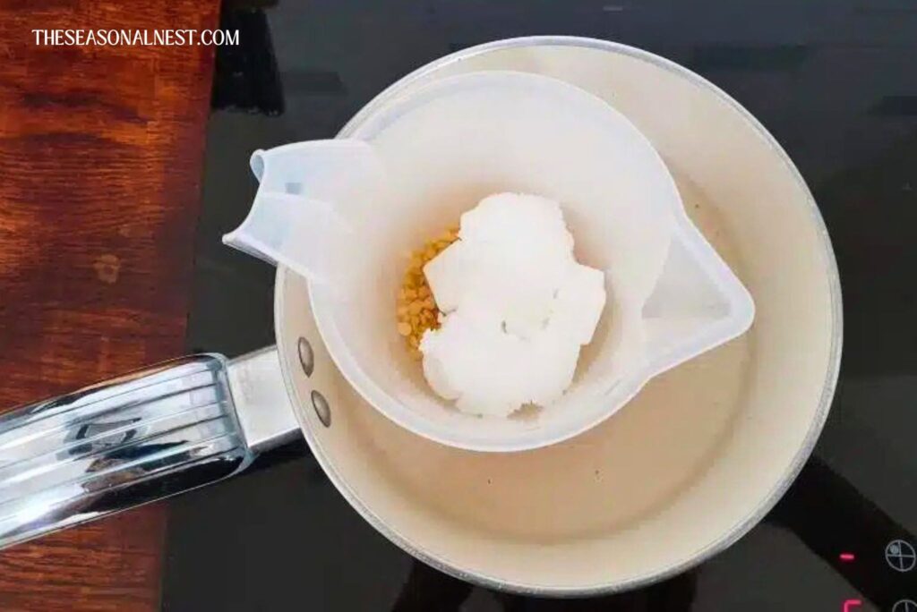 Melting beeswax, Shea butter and coconut oil in a pot