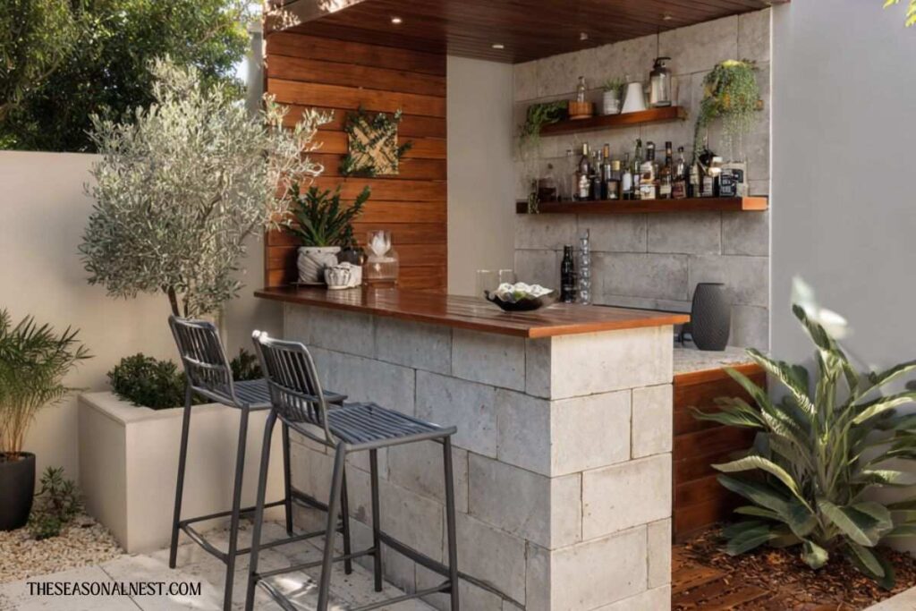 A bar with a concrete base and wooden shelves with stools in front.