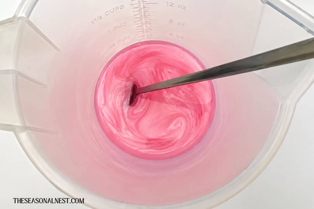Adding pink mica powder to the lip mixture
