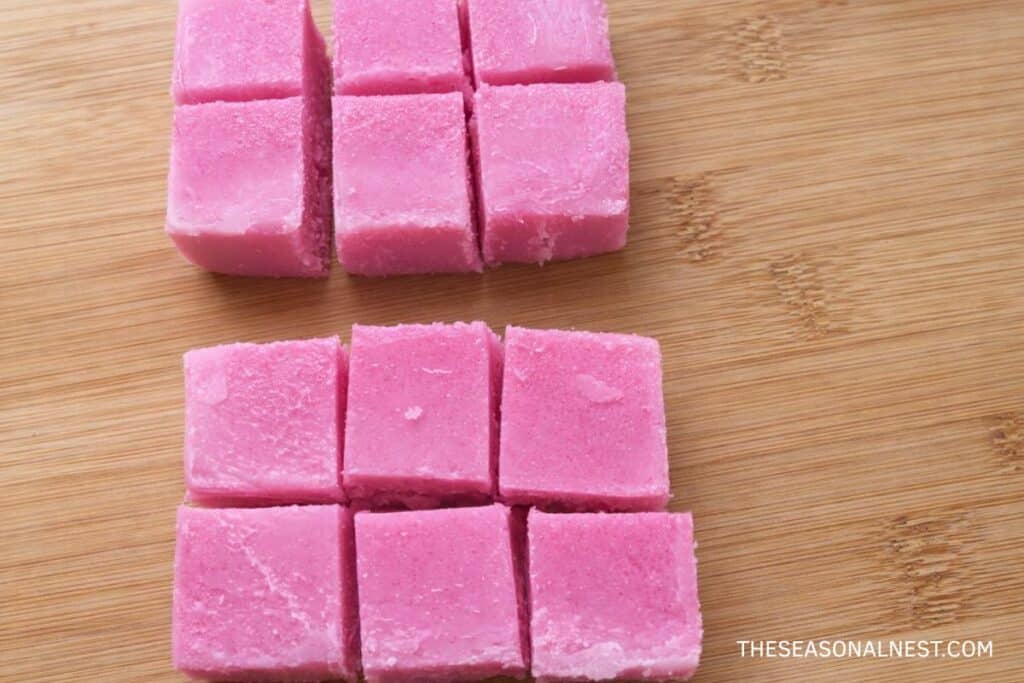 Cutting pink sugar scrub into cubes.