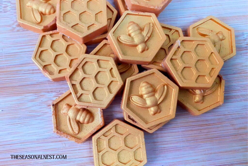 Homemade bronzing lotion bars on a wooden surface.