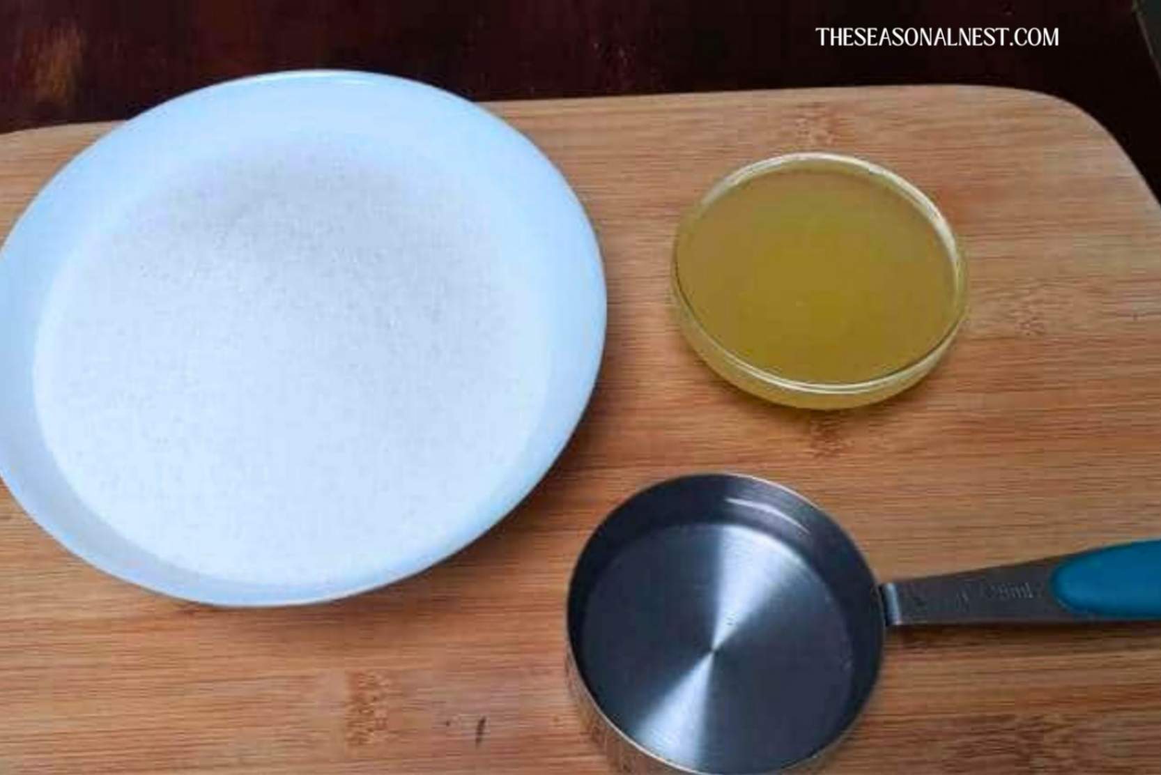 Sugar, lemon juice, and water on a wooden tray.